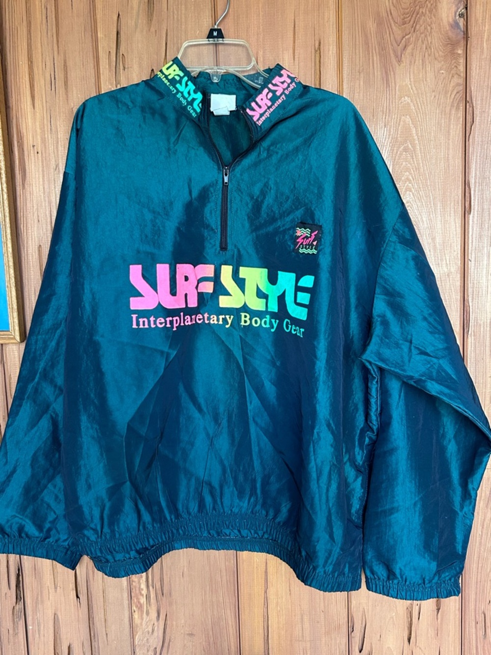 surf style Teal Windbreaker Pullover with Neon Pink and Neon Green Logo